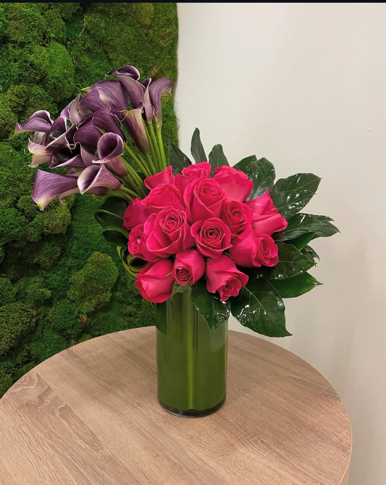 Velvet Majesty - "Velvet Majesty" is a luxurious and dramatic arrangement.  Deep pink roses and rich purple calla lilies are artfully arranged to create a striking and unforgettable display.  The rich textures and bold colors exude opulence and sophistication.