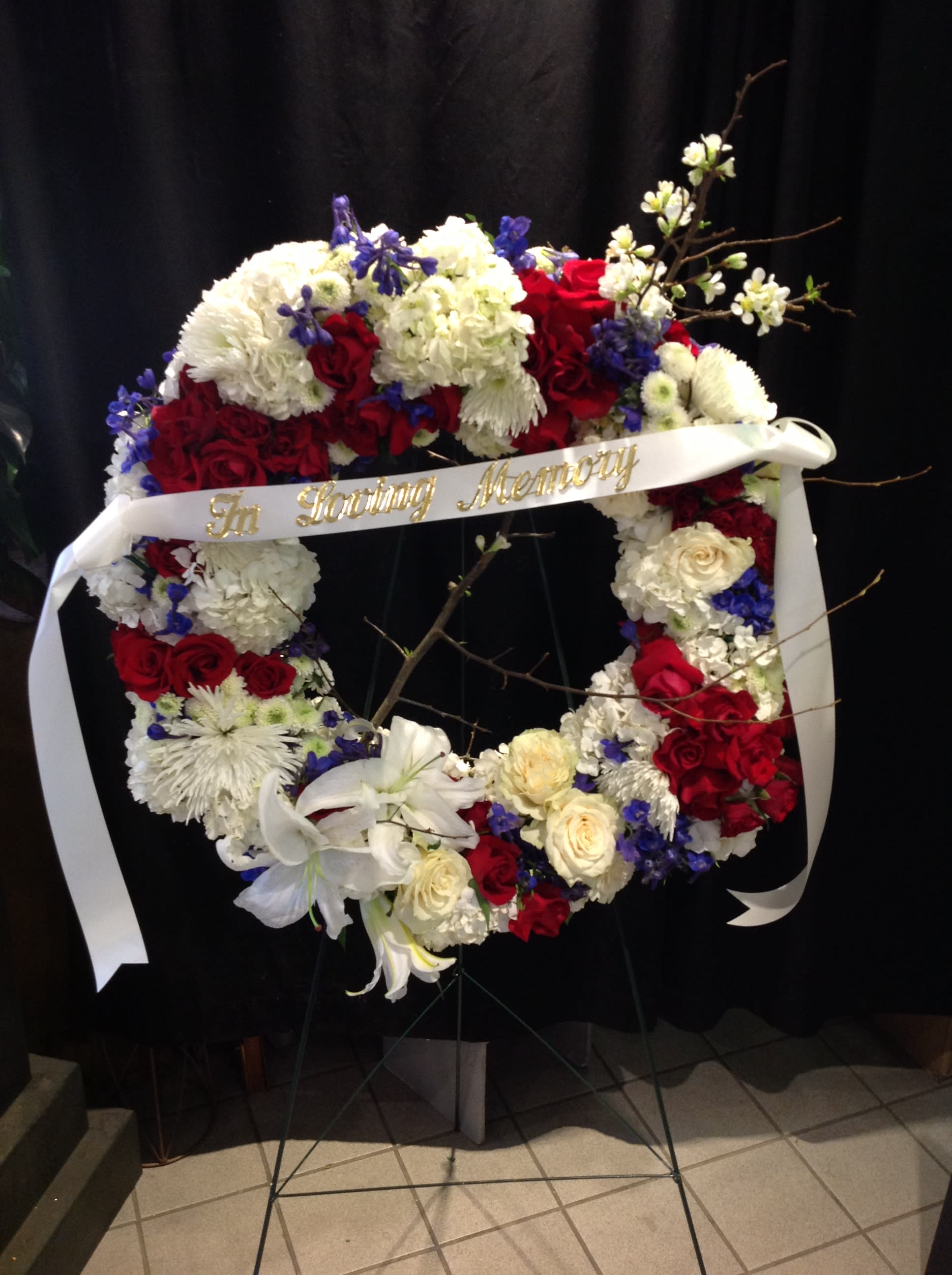 Unity - Patriotic red, white and blue wreath standing spray  *Pricing does not include banner*  *Flowers subject to change based on supply*