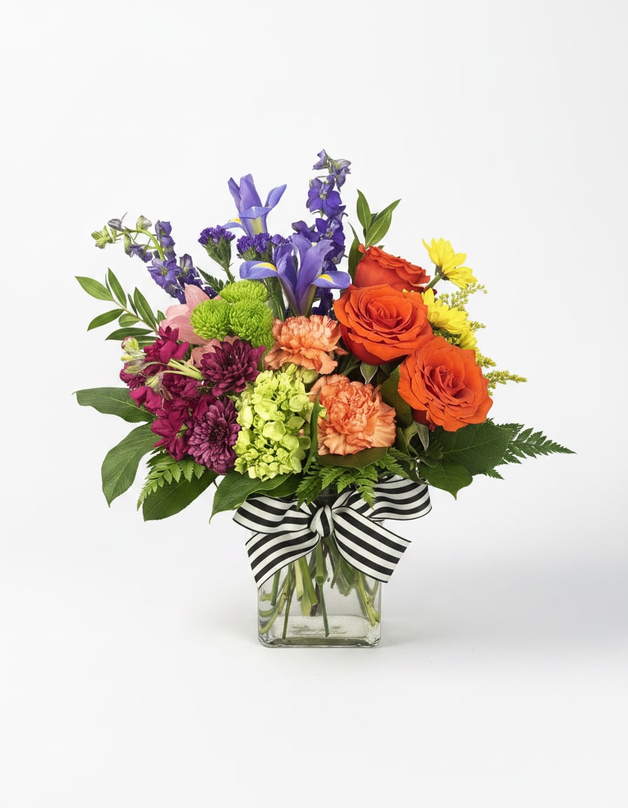 The Colorful Bouquet - All the colors in one place! This happy bouquet is sure to bring a smile to their face! Includes seasonal fresh flowers in the colors of orange, yellow, pink, purple, and green. Arrangement size: 11 Height, 7" Width. (Measurements are approximate).  Please Note: Standard Delivery for this product occurs in the afternoon, between 2:30pm and 7pm. If you need it by a certain time, there is an option to select a timed window for scheduled deliveries. 