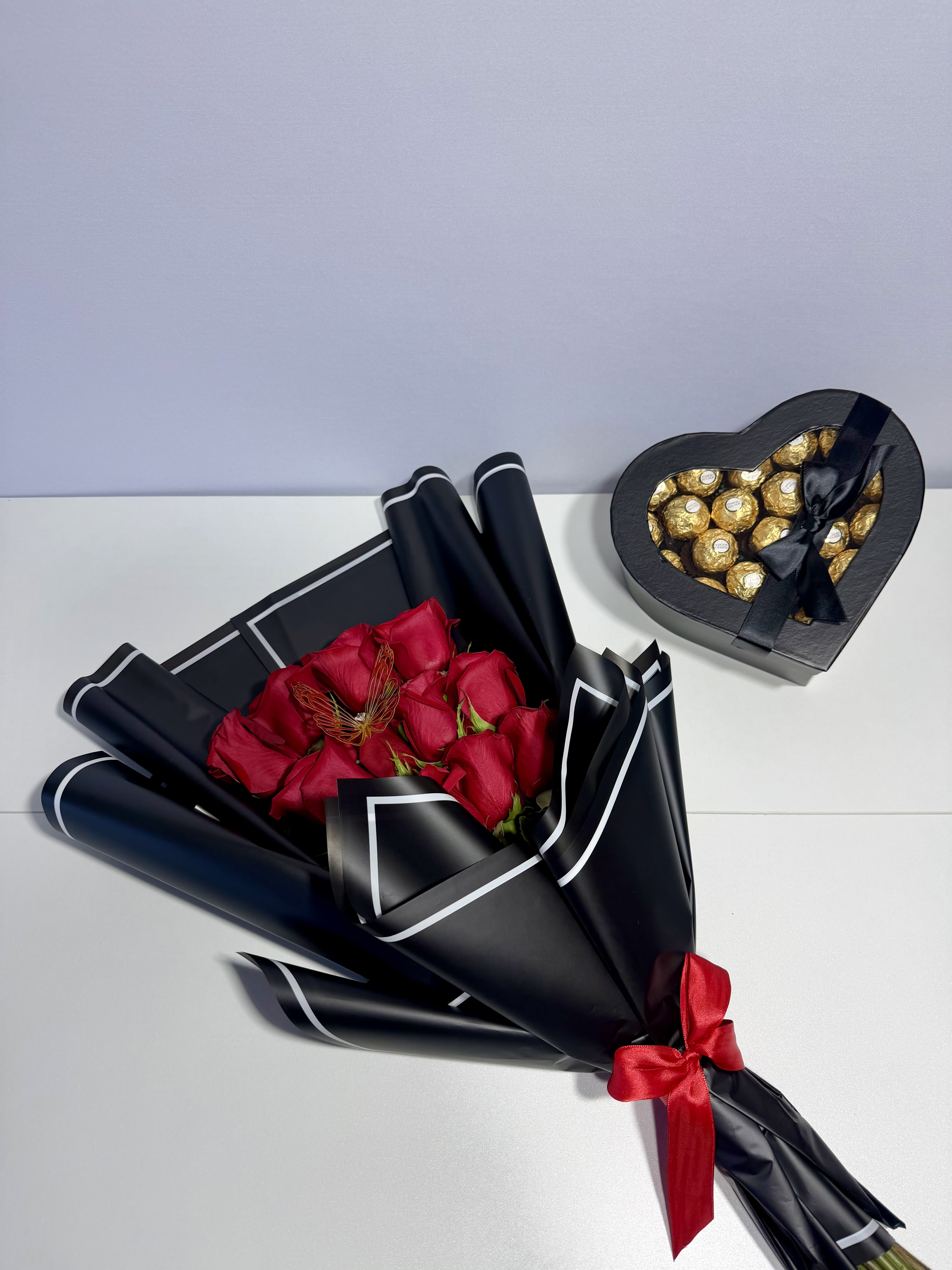 Midnight Romance - Elegant red roses wrapped in sophisticated black paper and paired with a heart-shaped chocolate box — thoughtfully designed for meaningful moments and unforgettable reactions.