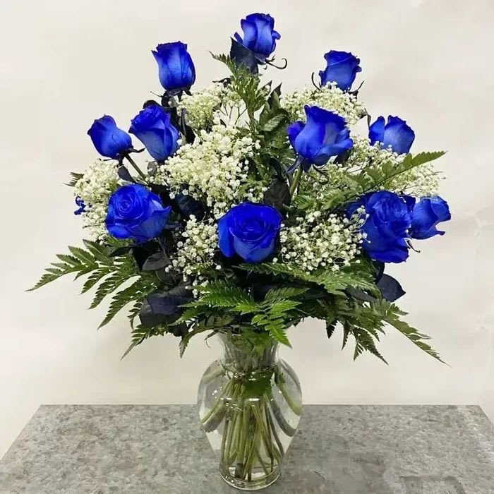 Blue Roses Dozen Vase Arrangement - Express your deepest emotions with this elegant dozen roses — the timeless symbol of love and passion. Carefully selected and artfully arranged, these fresh roses are perfect for anniversaries, romantic gestures, or simply saying “I love you.” as shown 12, better 18, best 24.