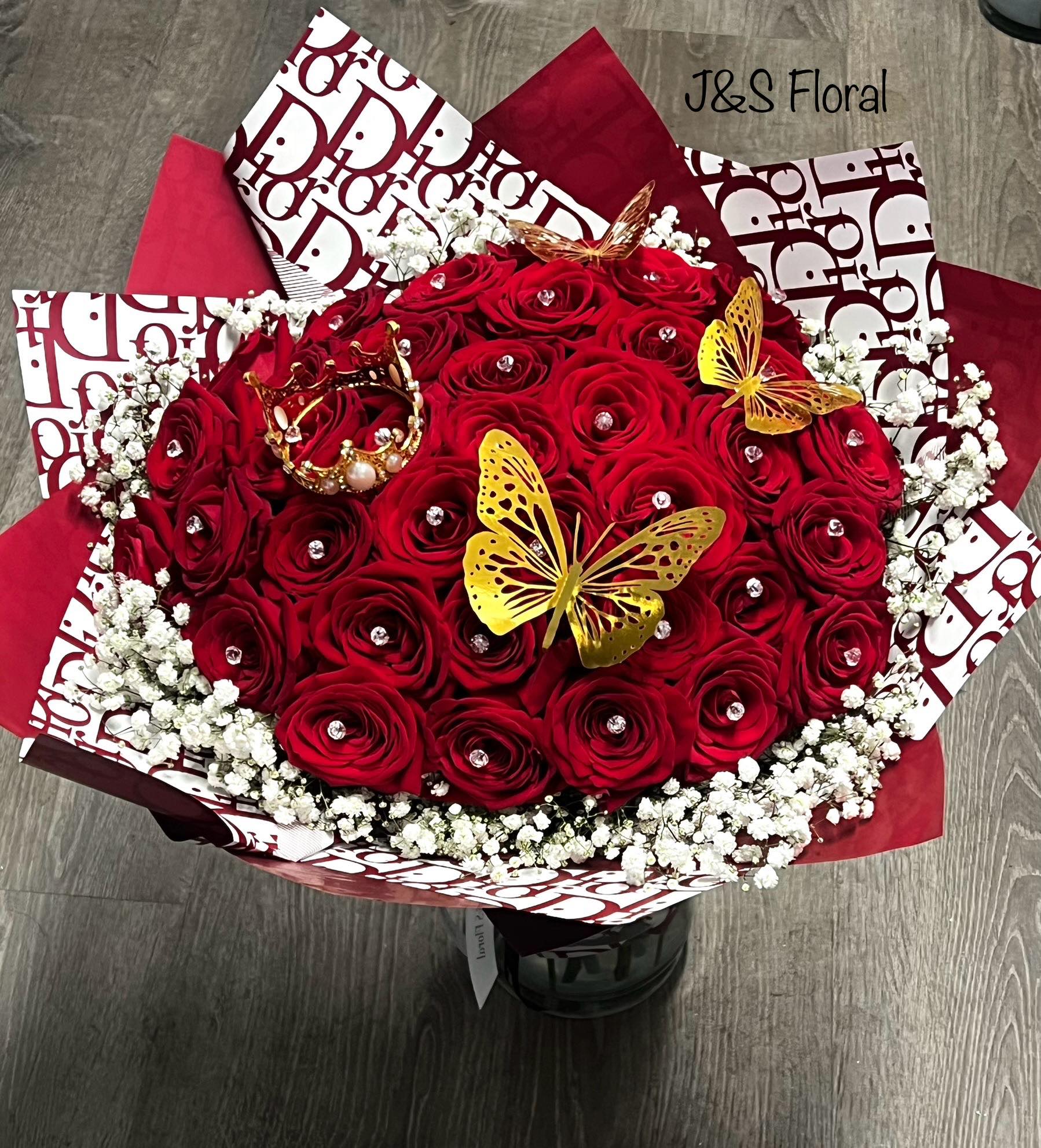 Red rose bouquet with white baby's breath and gold butterfly accents