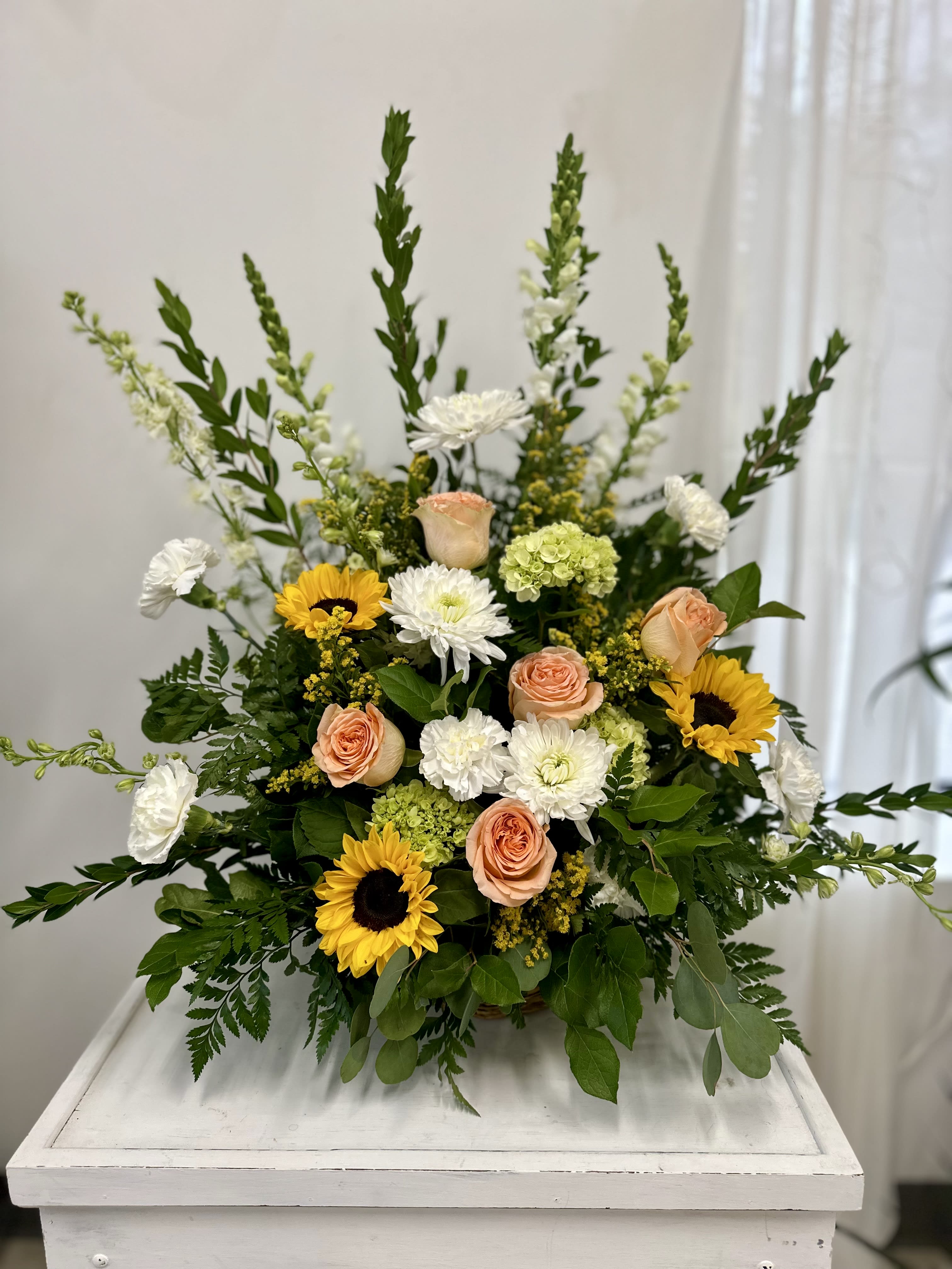 Mixed bouquet with sunflowers, peach roses, and white blooms
