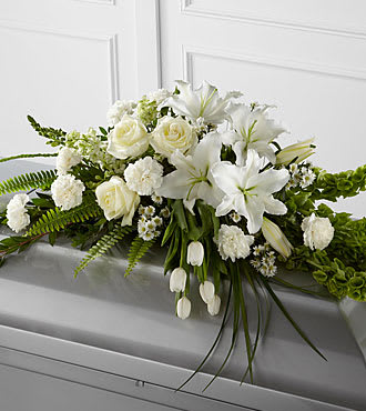White floral casket spray with roses and lilies