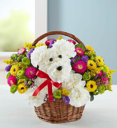 Basket of flowers arranged as a teddy bear with a red ribbon