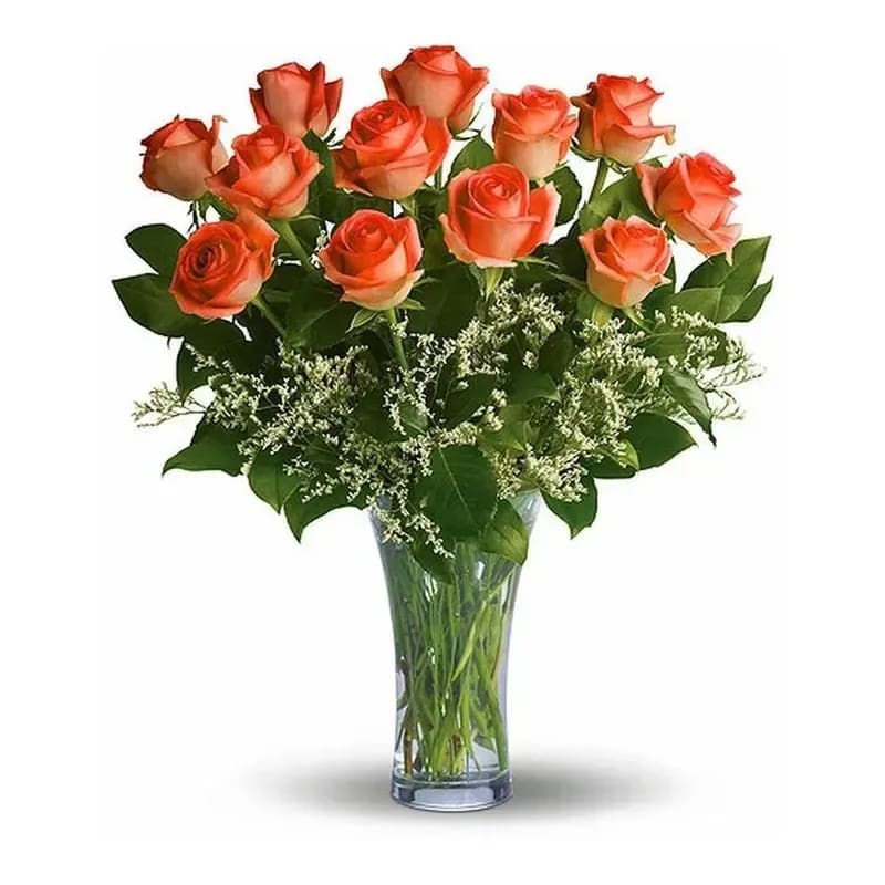 Orange roses arranged in a clear glass vase