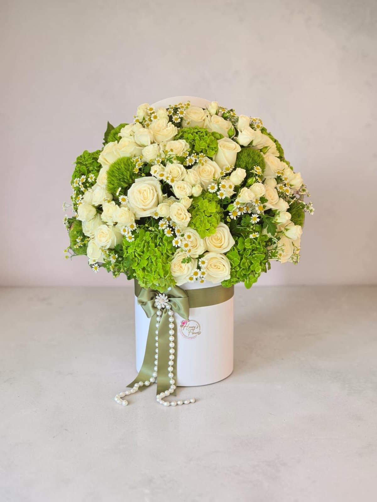 Esmeralda - A graceful blend of  white roses, fresh green hydrangeas, chamomile and white spry roses, beautifully arranged in a luxury box. A timeless gift for every special occasion.