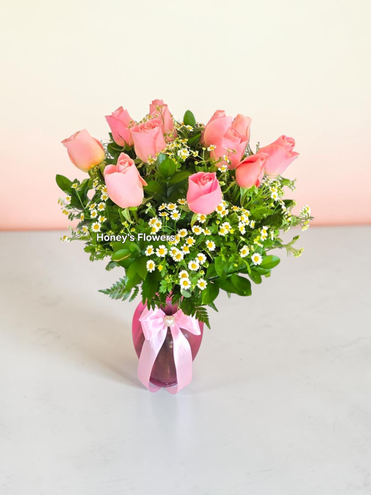 Simple Long Stem Baby Pink Roses - A beautiful arrangement featuring premium baby pink roses, delicate chamomile, pink ginger glass vase, and fresh green foliage. Elegantly designed to bring charm and sophistication to any occasion, making it a perfect gift.