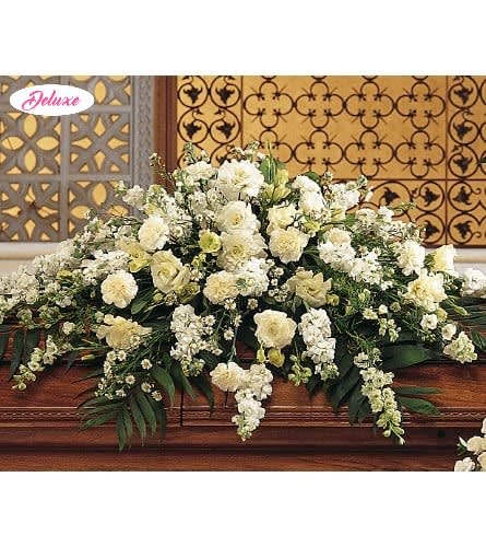 Forever at Peace  - Forever at Peace is an elegant casket cover designed to honor a cherished life with grace, serenity, and heartfelt remembrance. This timeless all-white floral tribute features a beautiful assortment of carnations, stock, larkspur, lisianthus, and Montecasino, thoughtfully arranged to create a peaceful and refined expression of sympathy. The delicate white blooms symbolize purity, peace, devotion, and the everlasting memories held close in our hearts. Handcrafted by our compassionate florists, Forever at Peace offers a meaningful way to celebrate a loved one’s life while providing comfort and support to family and friends during a time of loss. A graceful tribute reflecting tranquility, love, and eternal remembrance.