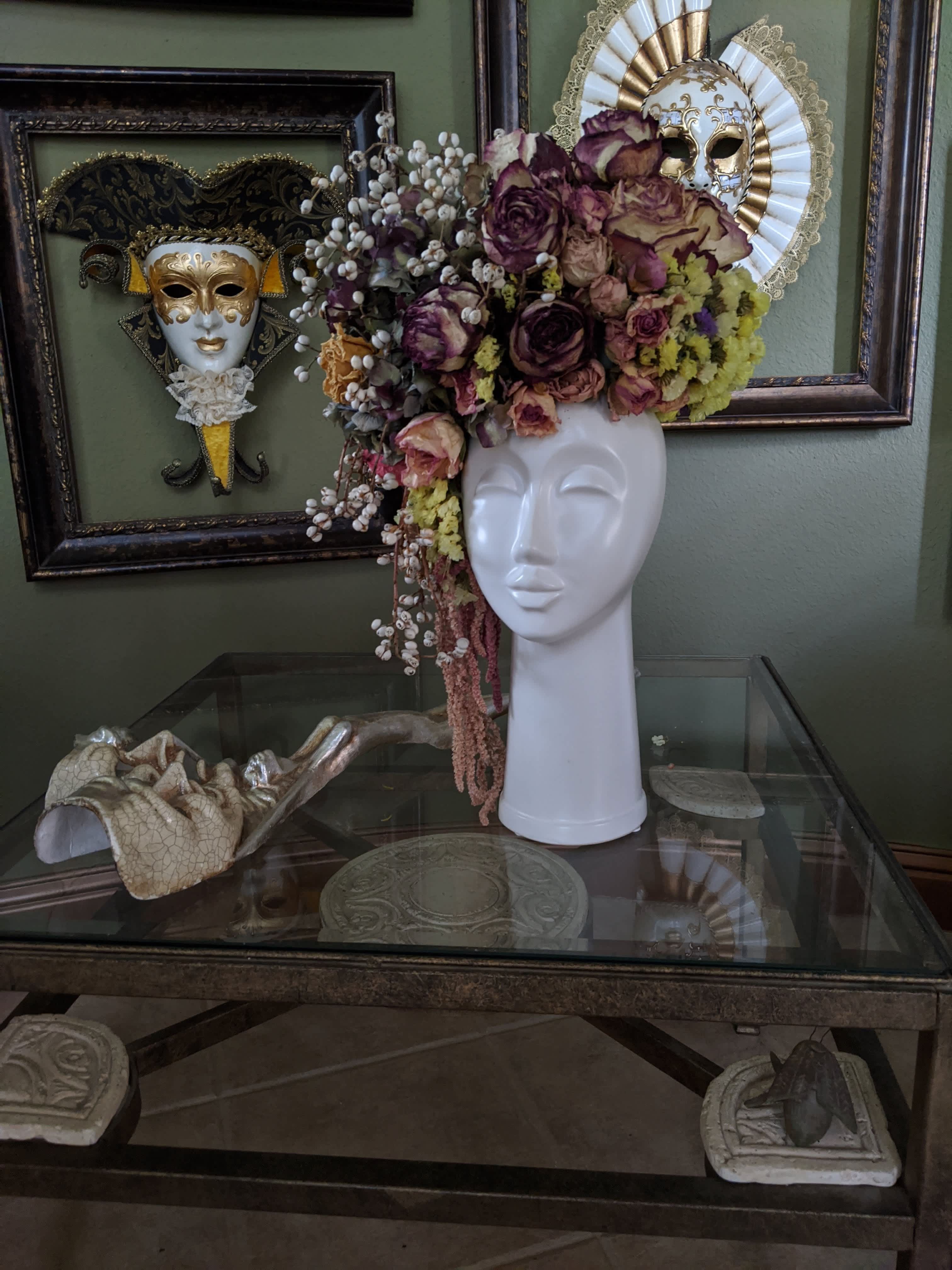 Floral headpiece on a white mannequin bust with purple and cream roses