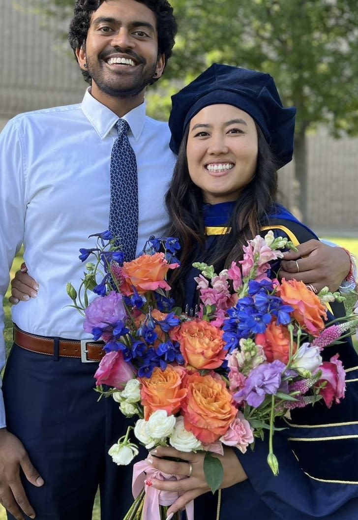 Graduation bouquet of orange, pink, and blue flowers