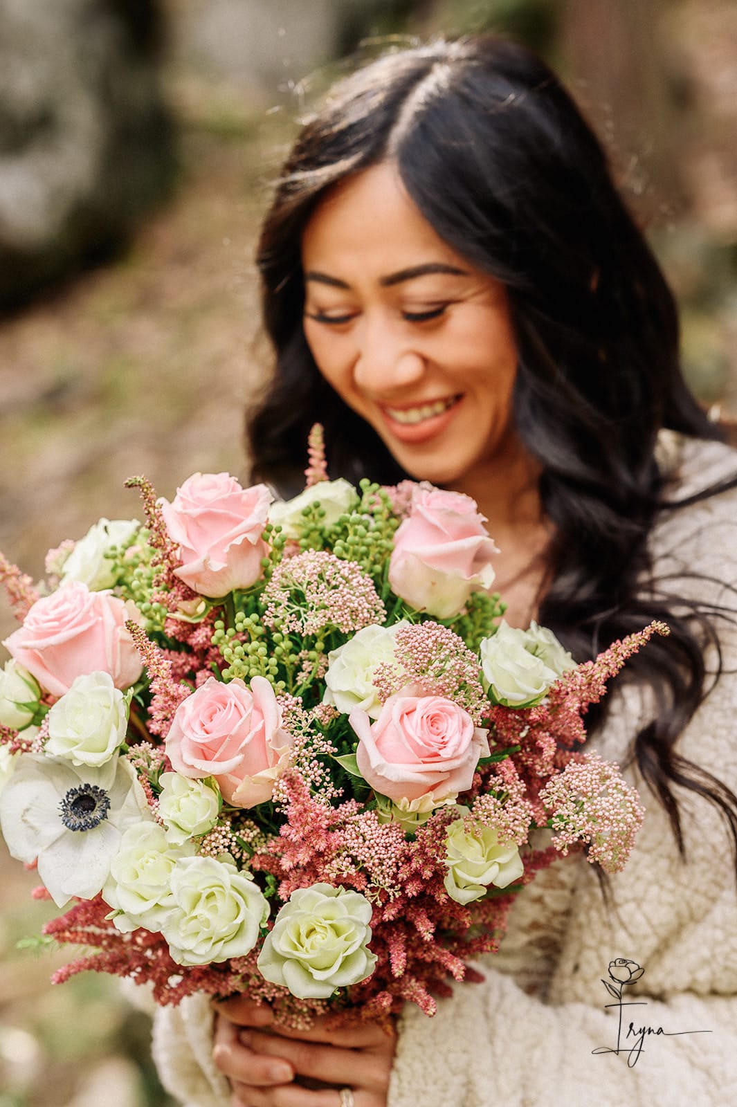 Woman holding a bouquet of pink and white roses