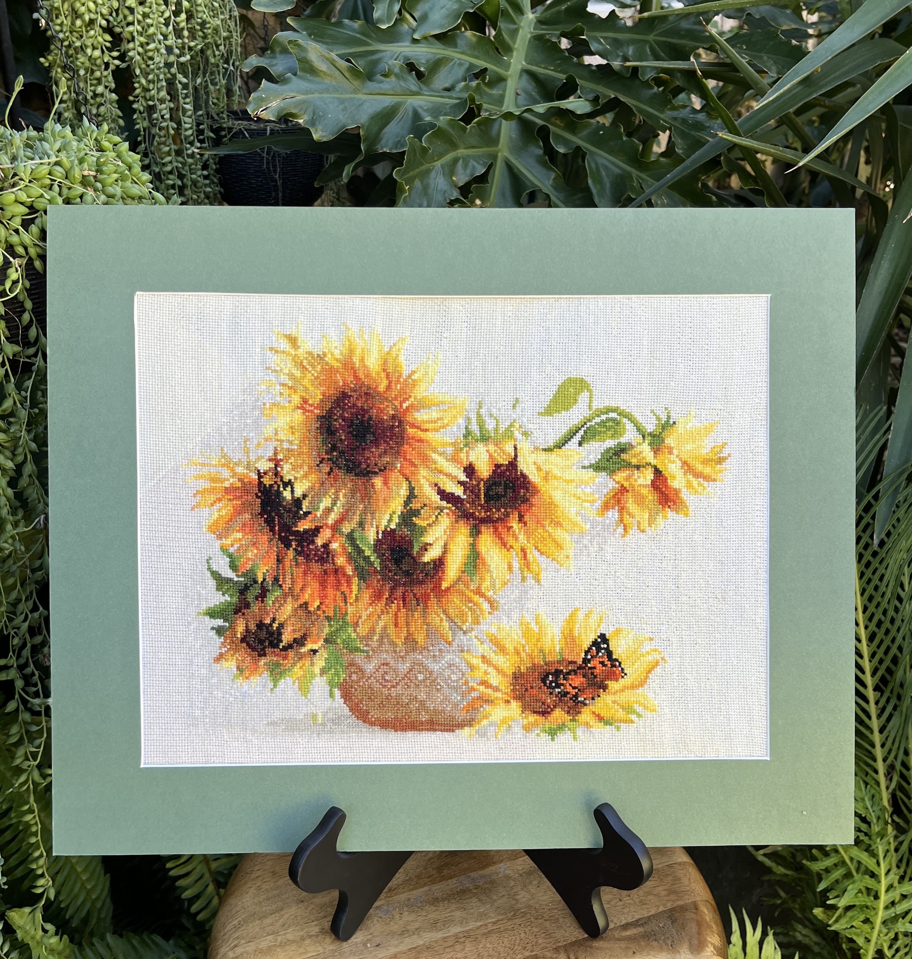 Framed sunflower artwork on an easel