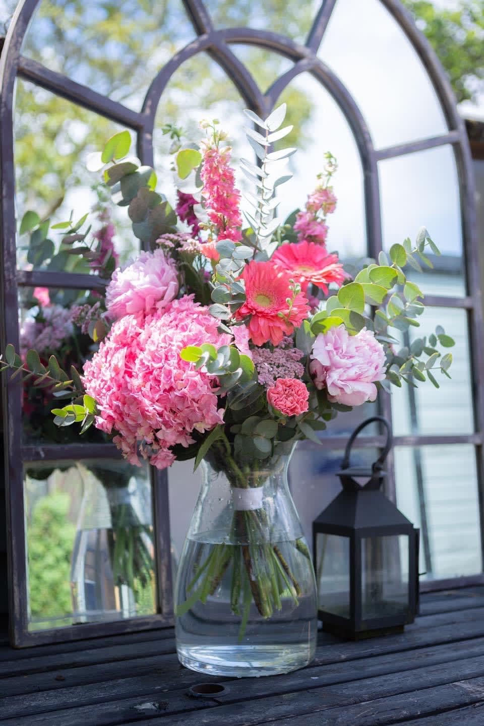 Pink mixed bouquet in a clear glass vase with eucalyptus