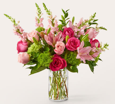Fit For A Queen - Fit for a Queen Bouquet reigns with regal Pink and Hot Pink Roses, elegant Lilies, and lush Hydrangeas, crowned with delicate Snapdragons and Ruscus greenery.  Presented in a stately glass vase, this luxurious arrangement is perfect for milestone birthdays, Mother's Day, or when only royal treatment will do.  Approximate Size: 21"H x 23"W. Send a touch of enchantment today!