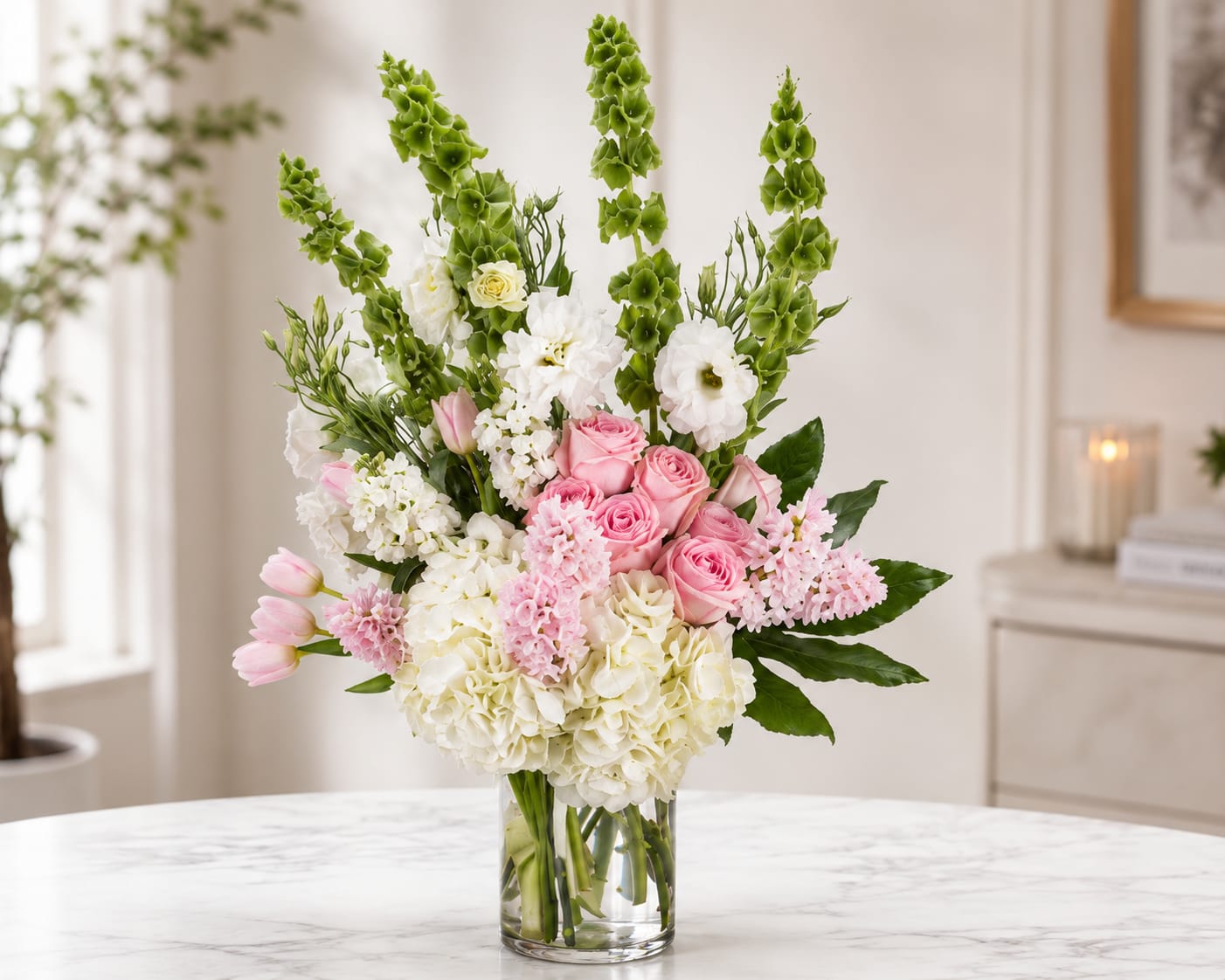 Blush &amp; Bloom Elegance - Indulge in the opulence of a giant luxury arrangement because when it comes to expressing your sentiments, why settle for ordinary? Rather than sending the traditional red roses, surprise them with something soft, pretty, and sweet to convey the message, "I care."  This extravagant arrangement is a testament to your thoughtfulness, showcasing the beauty of delicate and charming blooms that evoke tenderness and affection. It's a grand gesture, a visual feast, and a heartfelt expression of your care and appreciation.  Elevate your gift-giving to a whole new level, and let this exquisite arrangement speak volumes about the depth of your feelings. 