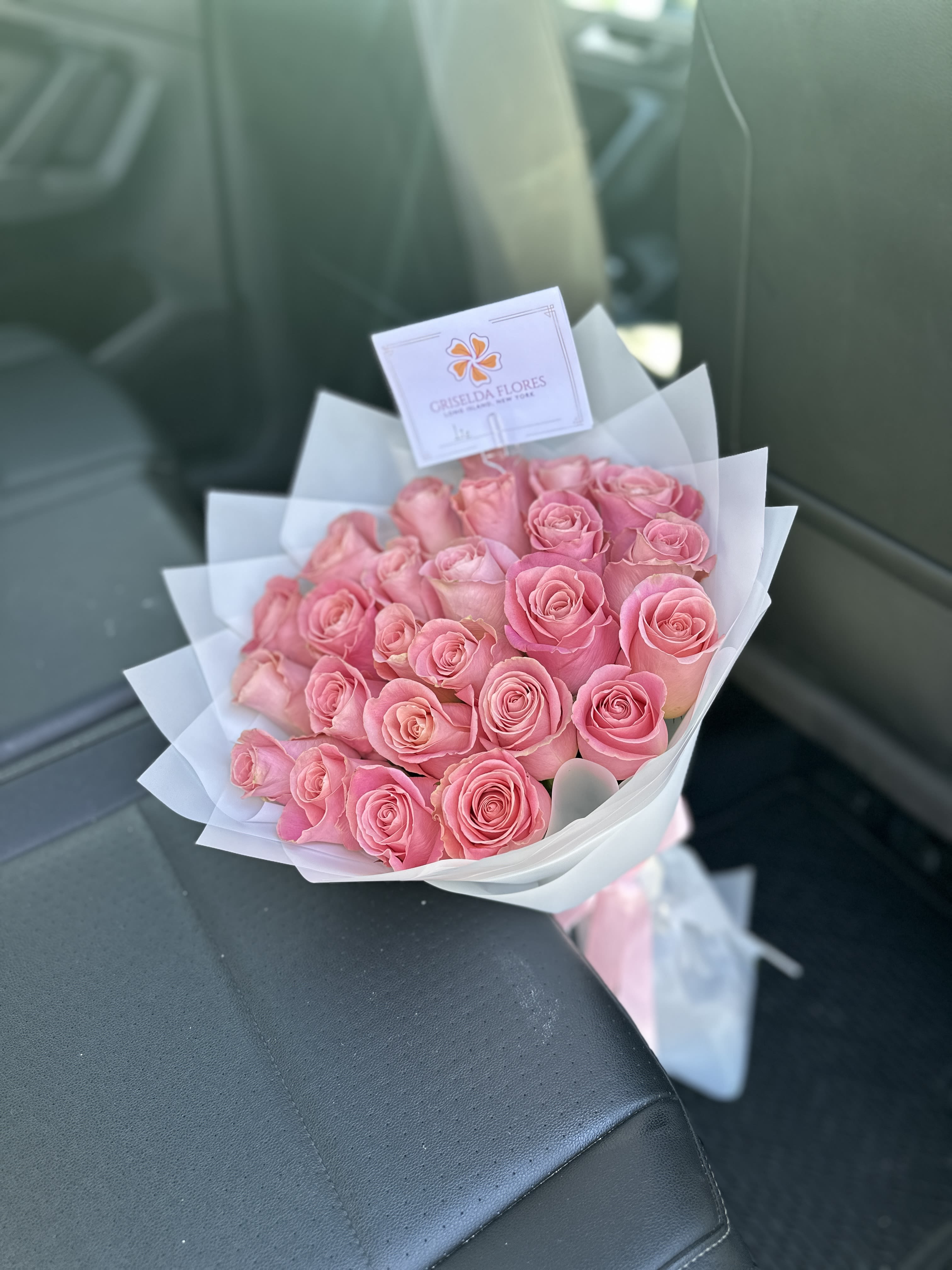 Bouquet of pink roses wrapped in white paper