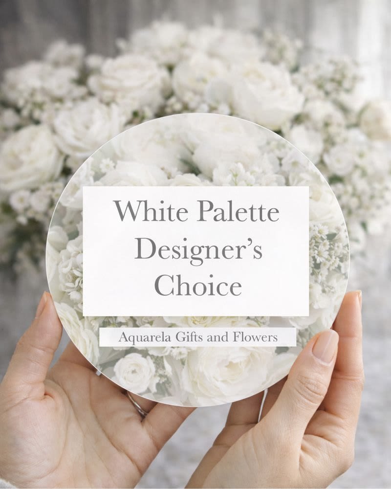 Hands holding a round card over a white flower arrangement