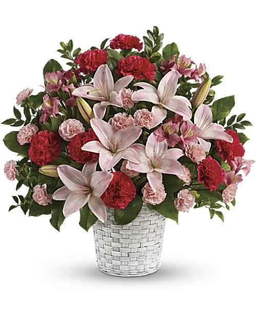 Sweet Basket - A beautiful bouquet expresses what words often cannot. Let the family know you are thinking of them with fragrant lilies and other favorites in a lovely  basket.The appearance of the basket may be different depends on available.  The radiant bouquet includes pink  lilies, pink alstroemeria,  pink &amp; red carnations and pink miniature carnations accented with assorted greenery. Delivered in a pot basket. Orientation: One-Sided