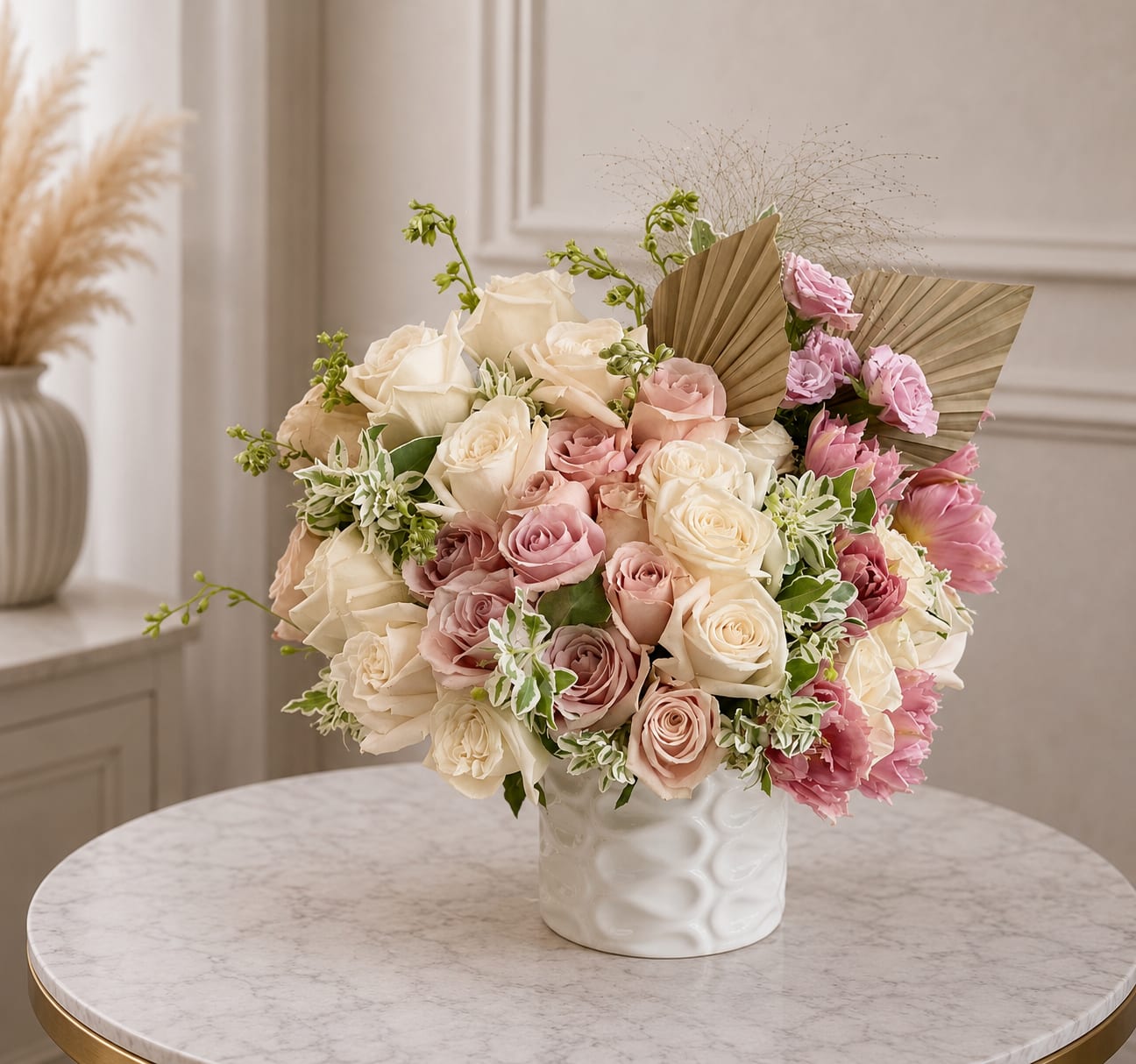 Velvet Veil - Velvet Veil is a romantic, luxury floral arrangement designed in soft layers of ivory, blush, nude, and muted mauve. Featuring premium roses, textural accents, delicate pink blooms, and sculptural dried elements, this design feels polished, feminine, and elevated while still maintaining a soft, organic movement.  Arranged in a modern ceramic vessel, Velvet Veil is ideal for birthdays, anniversaries, sympathy gestures, baby showers, client gifting, or simply sending something beautiful and unforgettable. The palette is understated yet rich, blending creamy whites and blush tones with soft garden textures for a look that feels timeless, graceful, and high end.  This arrangement is perfect for anyone drawn to elegant neutral florals with a romantic edge—something refined enough for a luxury gift and beautiful enough to style in the home.    luxury flower arrangement, blush and ivory floral arrangement, neutral flower arrangement, romantic rose arrangement, premium rose bouquet, elegant floral gift, luxury florist Orlando, high end flower delivery, blush roses arrangement, ivory rose centerpiece, feminine flower arrangement, soft pink floral design, luxury sympathy flowers, anniversary flower delivery, upscale floral arrangement, ceramic vase flower arrangement, luxury home floral styling, romantic floral centerpiece, Bloom In Glory flowers, garden inspired luxury florals