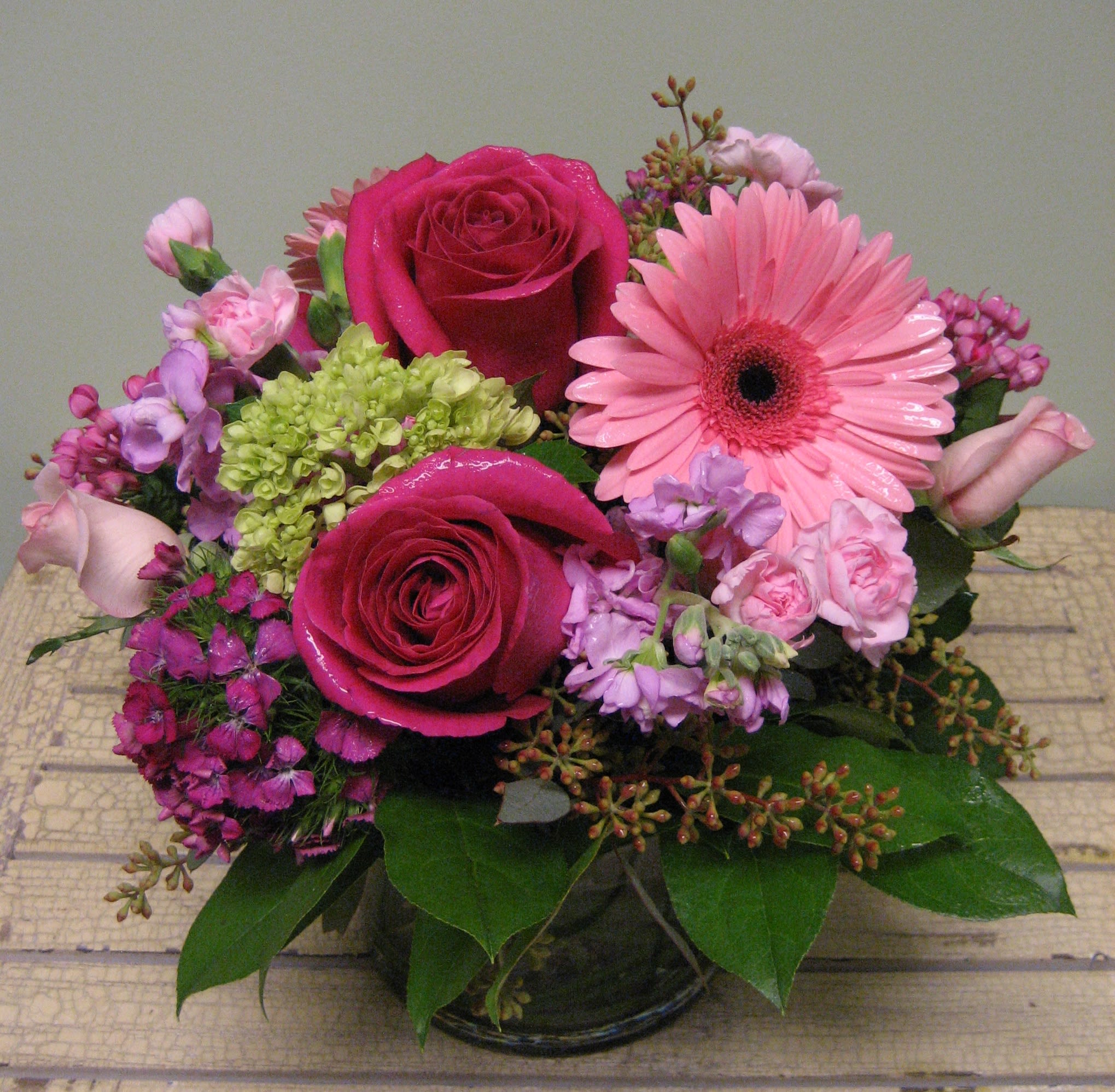 Pink and magenta flower arrangement in a glass vase