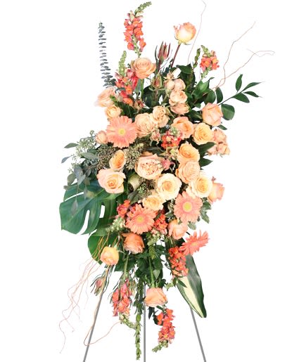 Tall peach and coral floral spray on an easel