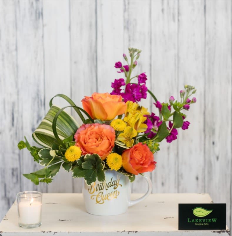 Colorful flower arrangement in a white mug with "Birthday Queen" text