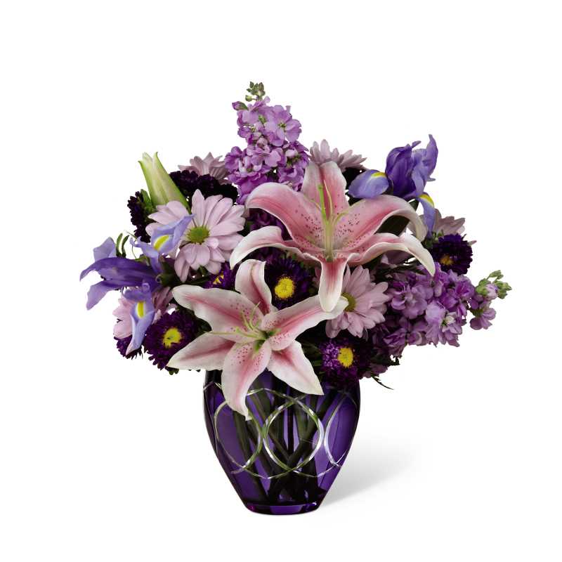 The FTD Radiant Bouquet  - The FTD Radiant Bouquet makes an inspired use of harmonizing and contrasting hues to color Mother's Day perfectly lovely for mom. Soft pink Oriental Lilies, ruffled columns of lavender gilly flowers, deep blue irises, lavender daisies, purple matsumoto asters and lush greens create a simply stunning arrangement in a deep purple glass vase encircled all around with sparkling, brilliant cuts. Besides making an excellent Mother's Day gift, this elegant bouquet can give a special lift to birthdays and anniversaries, or to send your thank you, get well, and congratulations.