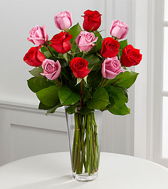 The FTD® True Romance™ Rose Bouquet - B19-4387S  The True Romance™ Rose Bouquet by FTD® is the perfect expression of love and passion. A bright burst of color, this bouquet combines red, pink and fuchsia roses, accented with beautiful greens and seated in a clear glass vase, to create a truly romantic representation of your love.