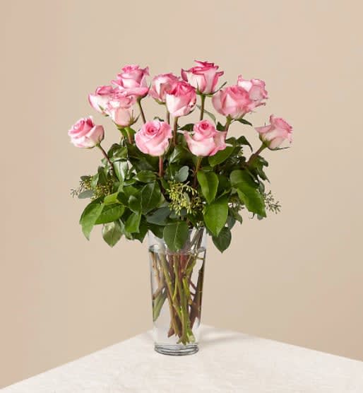 The Long Stem Pink Rose Bouquet - Picture-perfect soft pink roses make a beautiful gift for the lovely lady in your life. Wife, mother, daughter or sweetheart, she's sure to cherish this bouquet of pastel pink roses accented with seeded eucalyptus and arranged in a clear glass vase.  The Original Bouquet is approximately 18"H x 12"W.