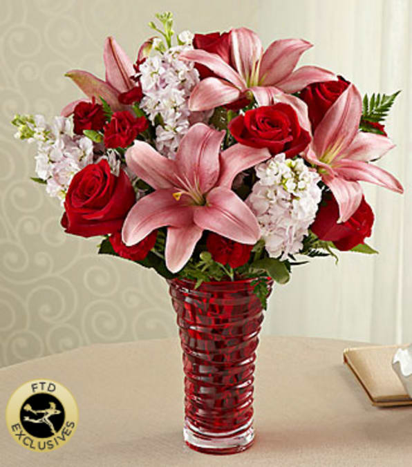 The FTD® Lasting Romance® Bouquet - Love blooms ever-so-sweetly with a mixed flower bouquet beautifully designed to deliver all that's in your heart. This exuberant composition of mixed flowers includes roses, lilies, stock and mini-carnations, all beautifully hand-arranged by an FTD artisan florist in a heavy, red glass, contemporary-styled vase. No matter who you're celebrating, this rich and lovely bouquet is bound to make a lasting romantic impression. Your purchase includes a complimentary personalized gift message.
