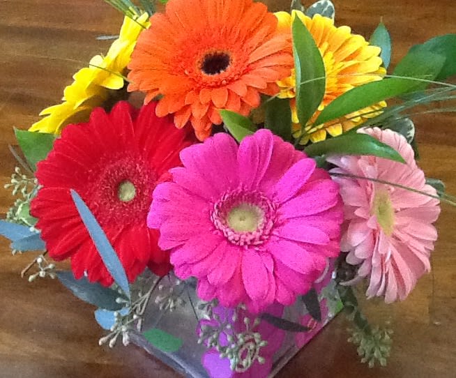 Bright gerbera daisy bouquet in pink, red, orange, yellow, and pale pink