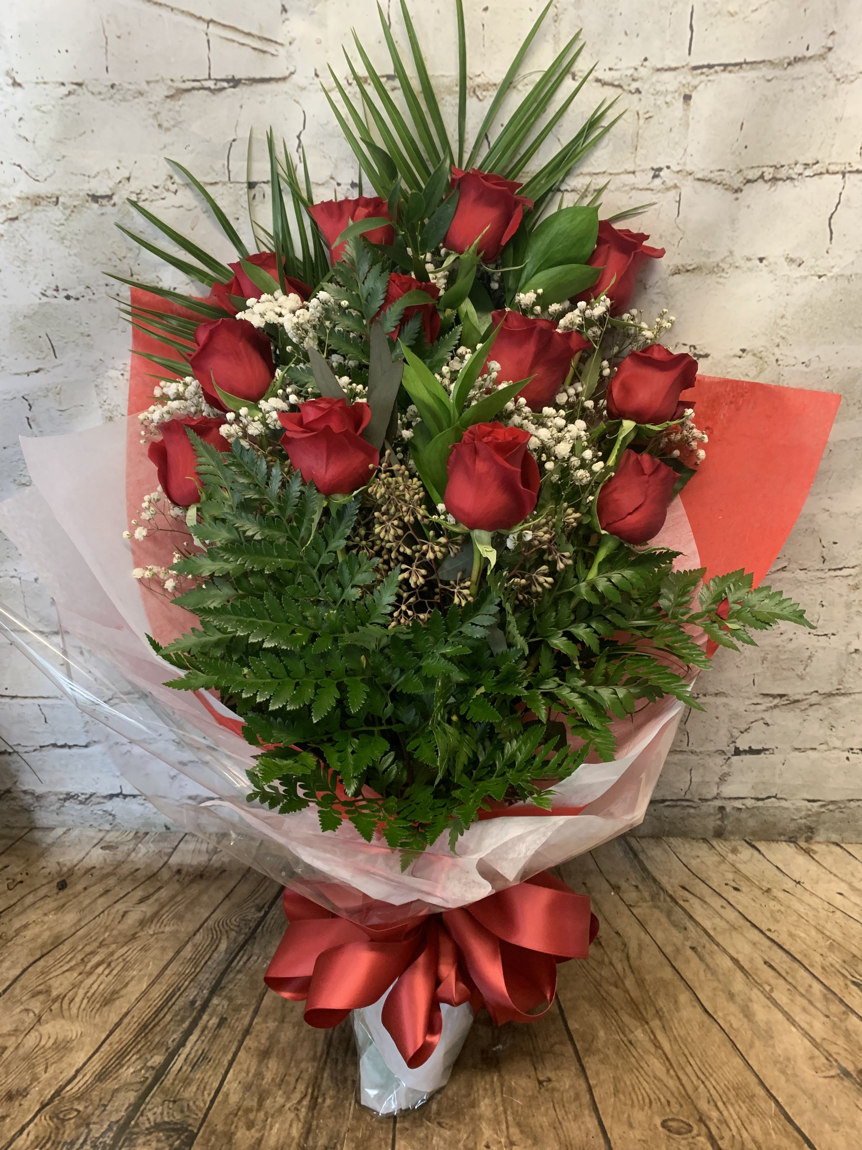 Bouquet of red roses with baby's breath and a red ribbon wrap