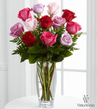 The FTD® Captivating Color™ Rose Bouquet by Vera Wang - VW3S  FTD® proudly presents the Captivating Color™ Rose Bouquet by Vera Wang. Bursting wth brilliant hues to capture their attention, these beautiful roses in the colors of fuchsia, red, pale pink, light lavender and purple are brought together with fresh, lush greens and perfectly arranged in a modern clear glass vase to create a wonderful way to convey your warmest wishes. GOOD bouquet is approximately 20"H x 14"W.