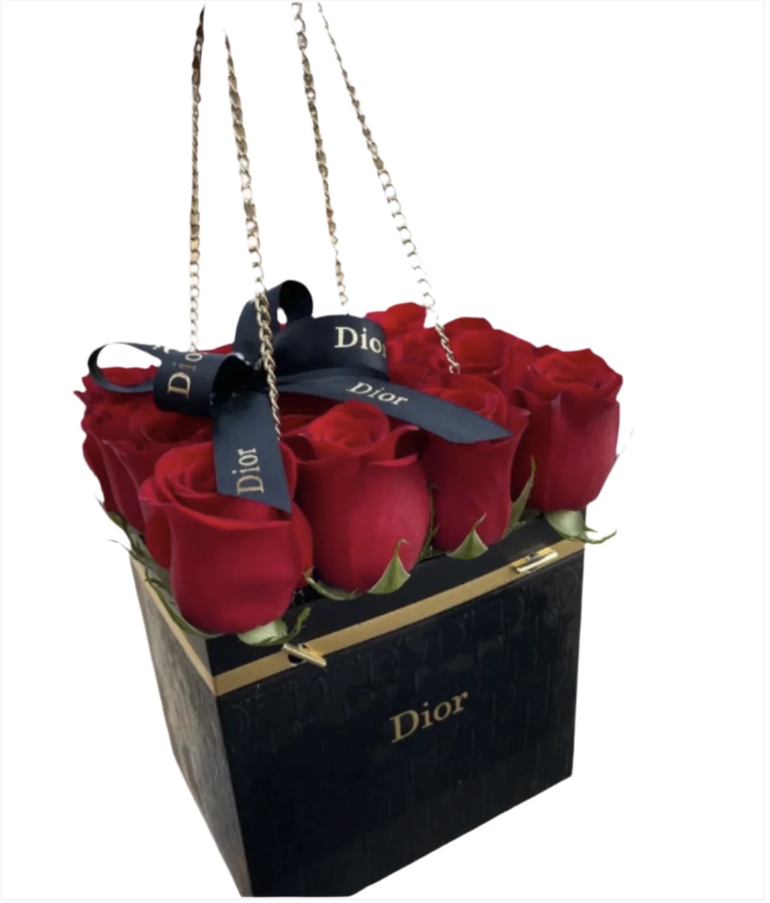 Red roses arranged in a black Dior gift bag with ribbon handles