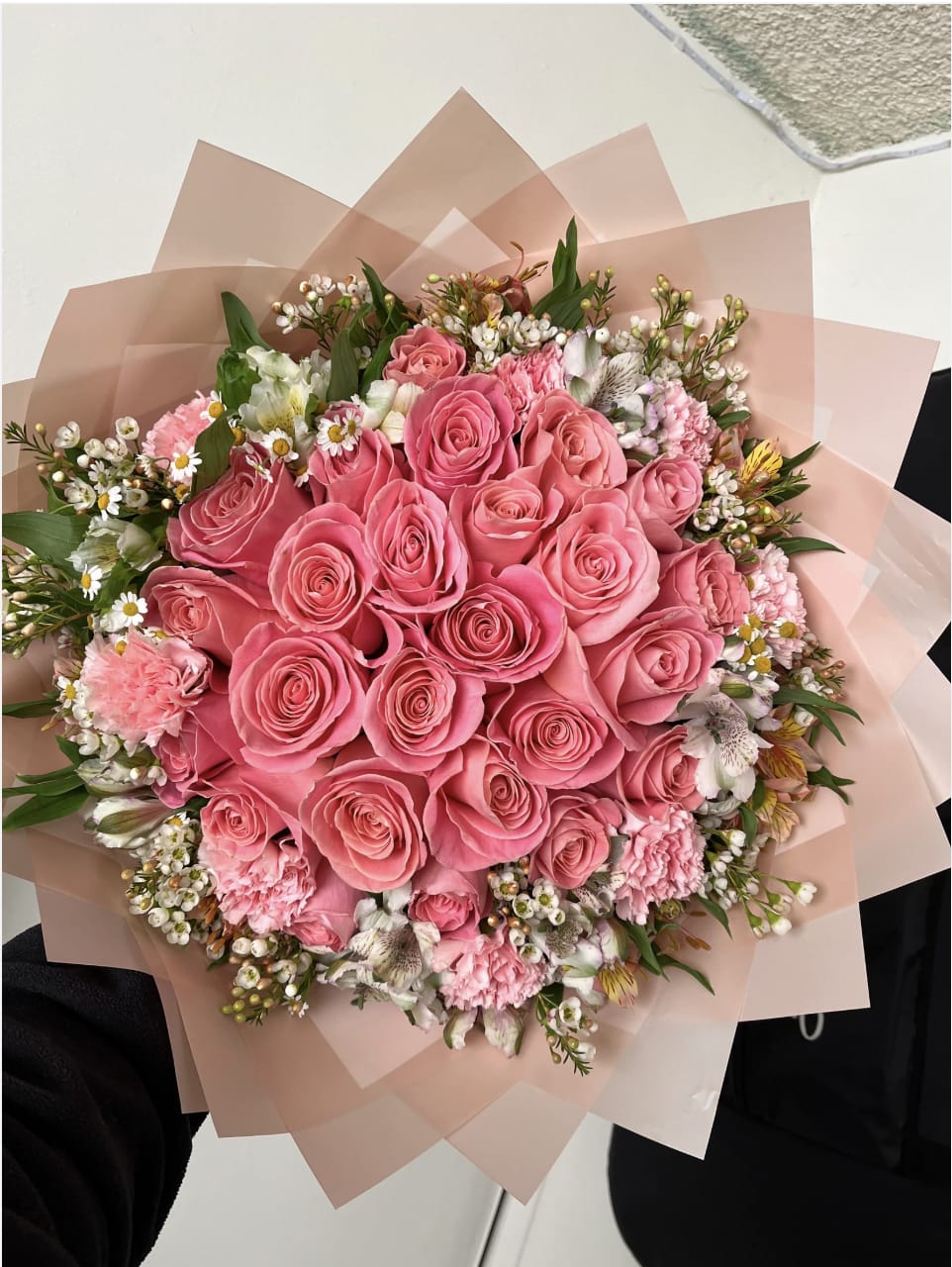 Pink rose bouquet with mixed small flowers wrapped in blush paper