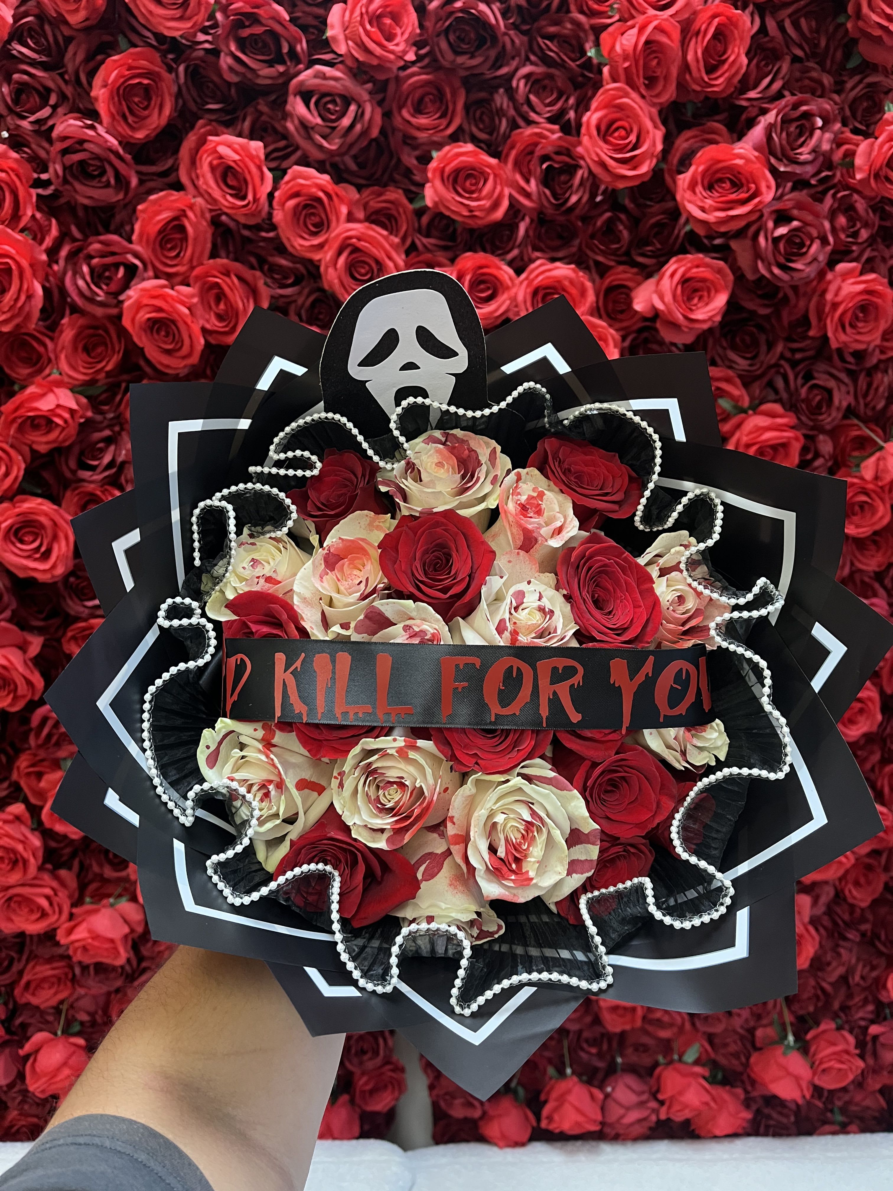 Bouquet of red and cream roses with a skull decoration