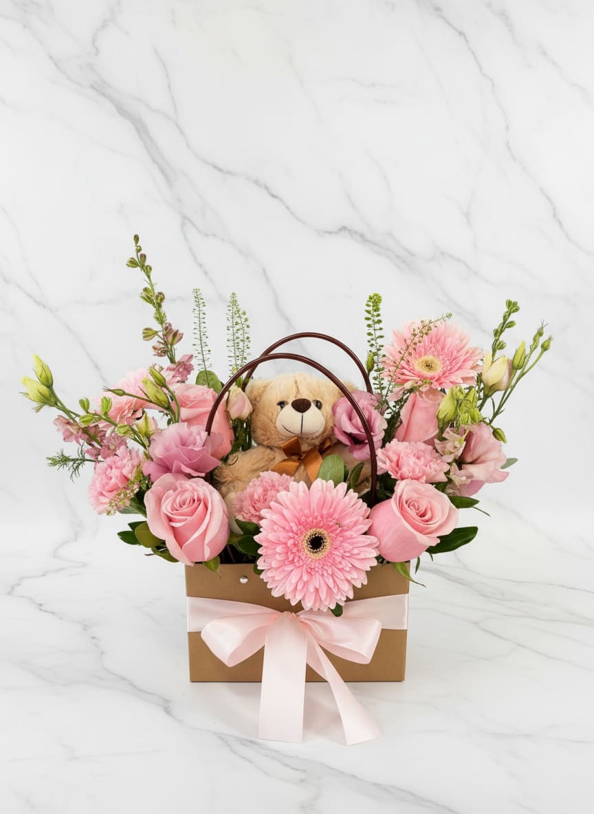 Pink flower basket with a teddy bear and ribbon