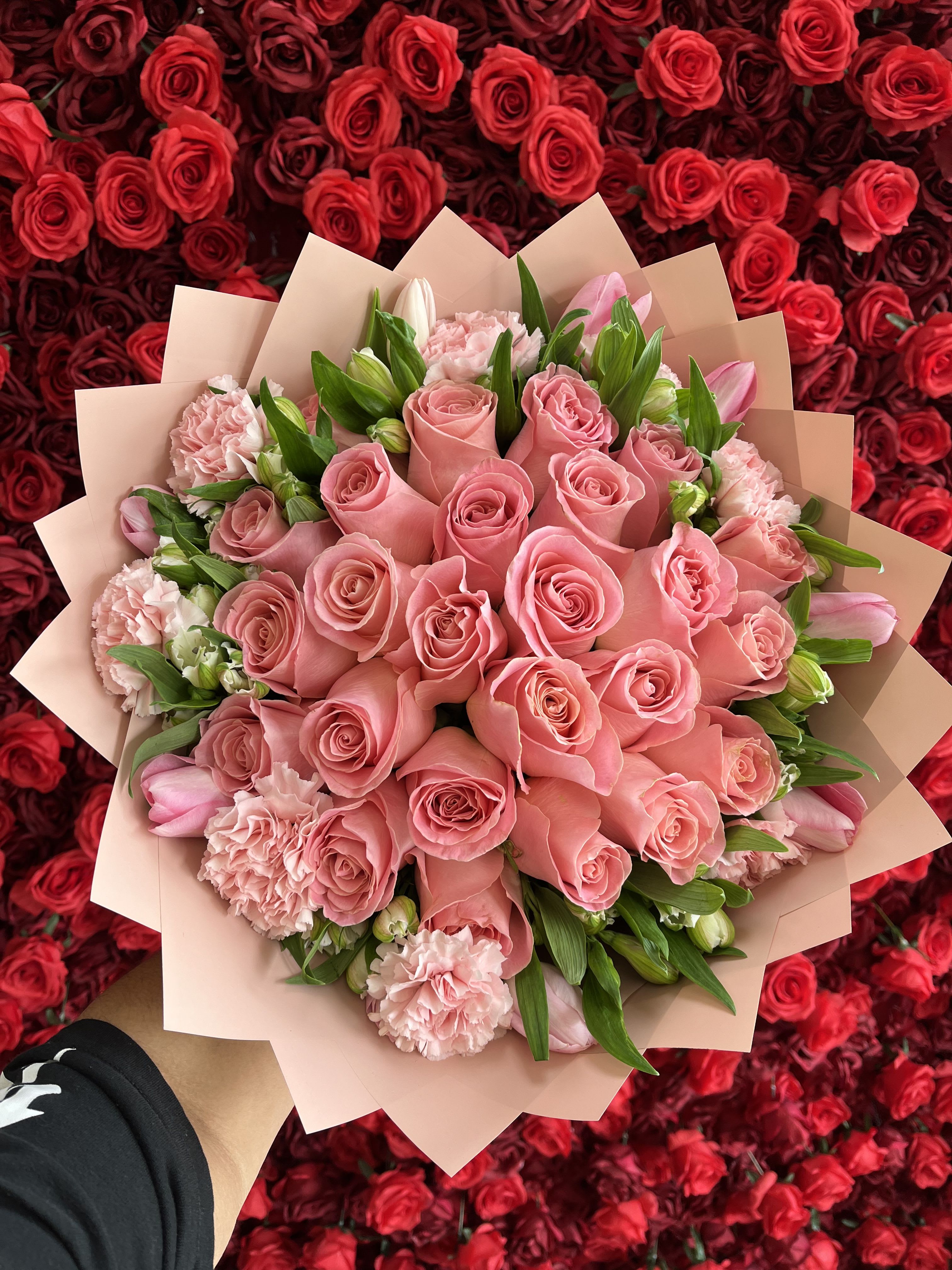 Pink rose bouquet with carnations and tulips wrapped in blush paper