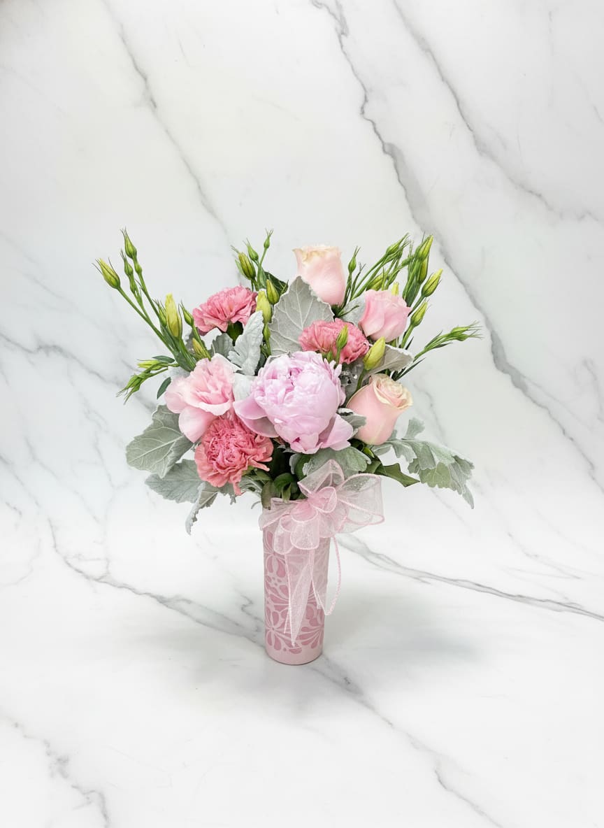 Peony Ceramic Cup - Soft pink roses, carnations &amp; lisianthus with pale foliage in a decorated pink ceramic cup, finished with a sheer ribbon bow - a gentle, romantic choice for Mother's Day or spring gifting.