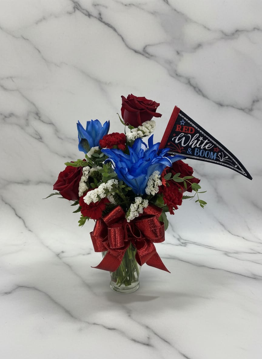 Mini Red white &amp; Boom vase - Deep red roses paired with vivid blue-dyed blooms and crisp white filler flowers create a compact, patriotic bouquet perfect for a Fourth of July or Memorial Day gift. The Mini Red White &amp; Boom vase makes a bold tabletop statement-she'll feel noticed and celebrated when this upright arrangement arrives.