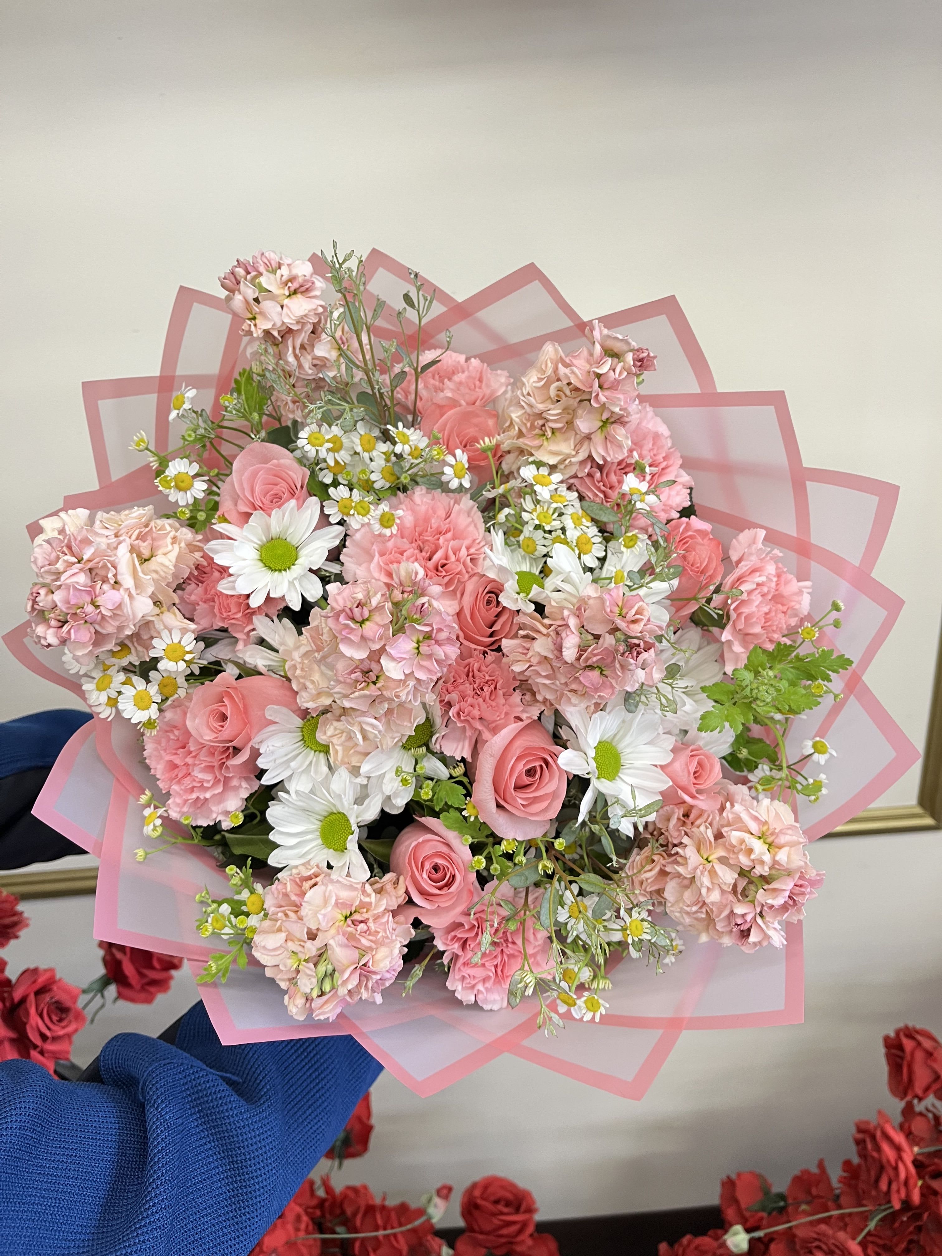 Pink Spring - A charming mix of white daisy poms, soft pink roses, blush stock, chamomile, and fresh eucalyptus. This delightful arrangement exudes natural beauty and elegance for brightening any day.  Note: PICTURED IS THE DELUXE SIZE. This arrangement features fragrant Stock flower and is not recommended for those with allergies.