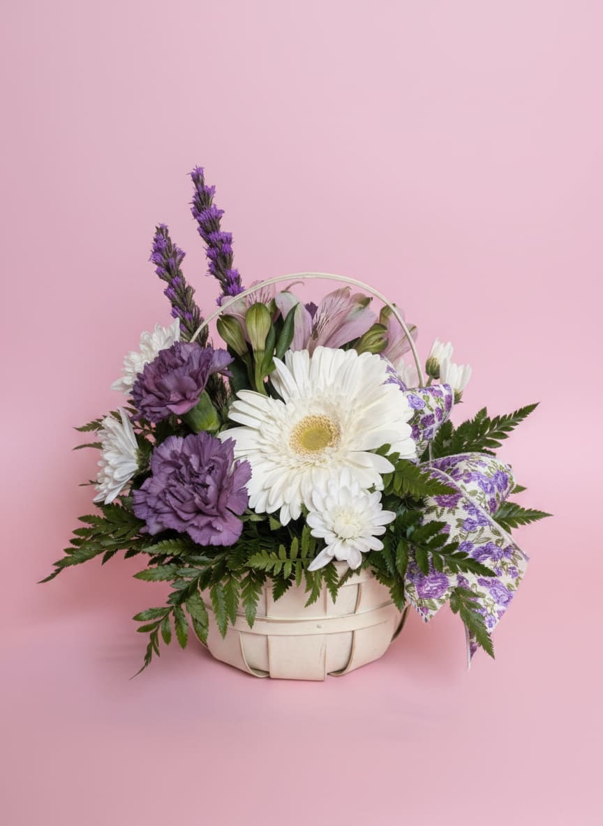 Gathered Grace  - Thoughtfully designed with an effortless, gathered-from-the-garden feel, Gathered Grace blends soft whites with muted lavender hues in a timeless woven basket. Featuring premium seasonal blooms, delicate textures, and natural movement, this arrangement is finished with an elegant vine ribbon for a refined, organic touch.  Designed to feel both fresh and timeless, Gathered Grace is a beautiful way to celebrate life’s meaningful moments—from birthdays and anniversaries to expressions of sympathy, gratitude, or simply letting someone know they’re loved.  Each arrangement is handcrafted by the designers at Moose Lake Florists, ensuring every piece is unique while staying true to its natural, garden-inspired style. The woven basket makes a beautiful keepsake long after the flowers have been enjoyed.  *Flower varieties, ribbon, and basket styles may vary based on seasonal availability while maintaining the overall color palette, style, and value.*