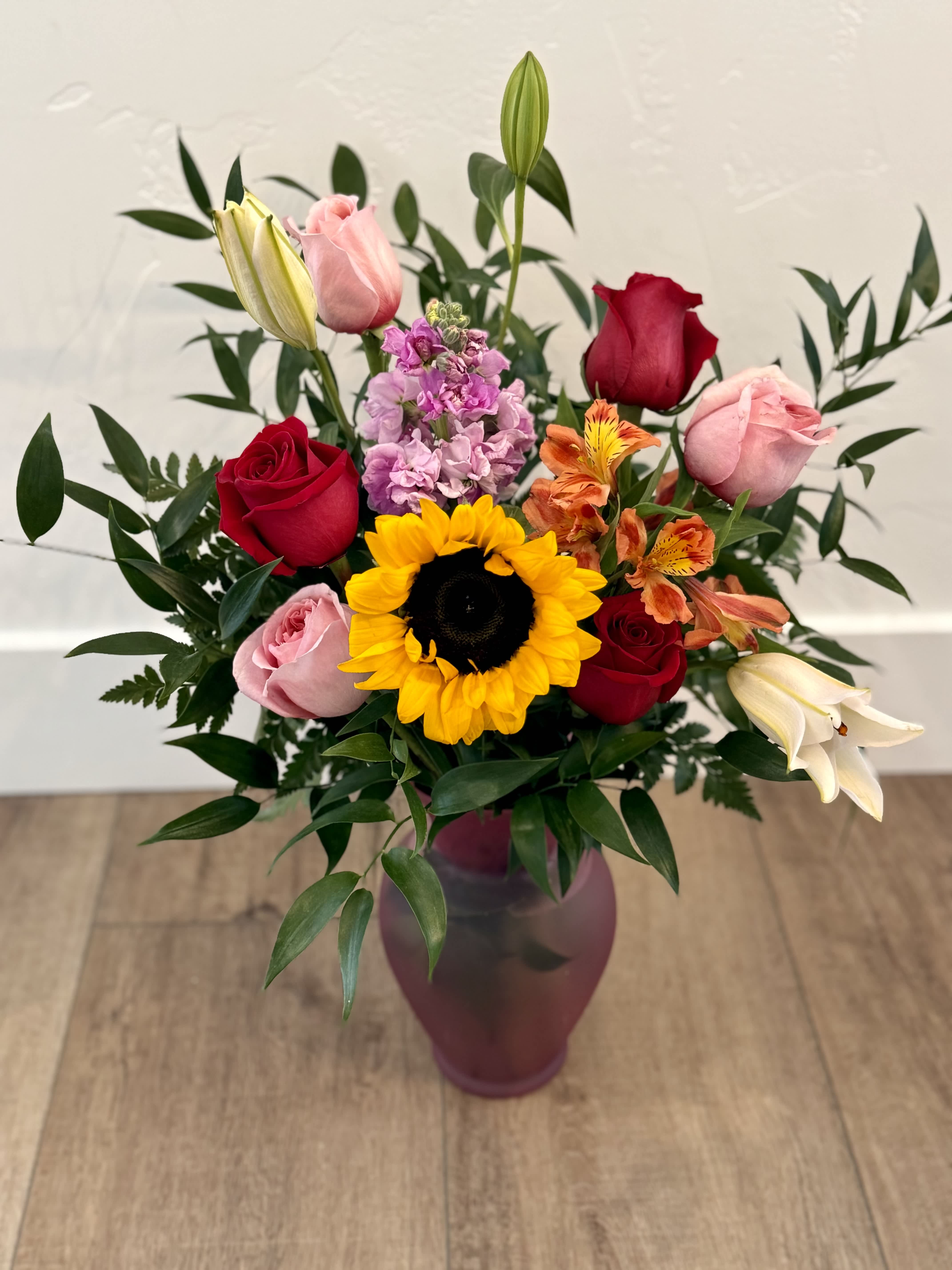 Savage Love - Featuring Sunflowers, 1/2 dozen roses, stock, alstroemeria and Fill arranged in a beautiful vase 