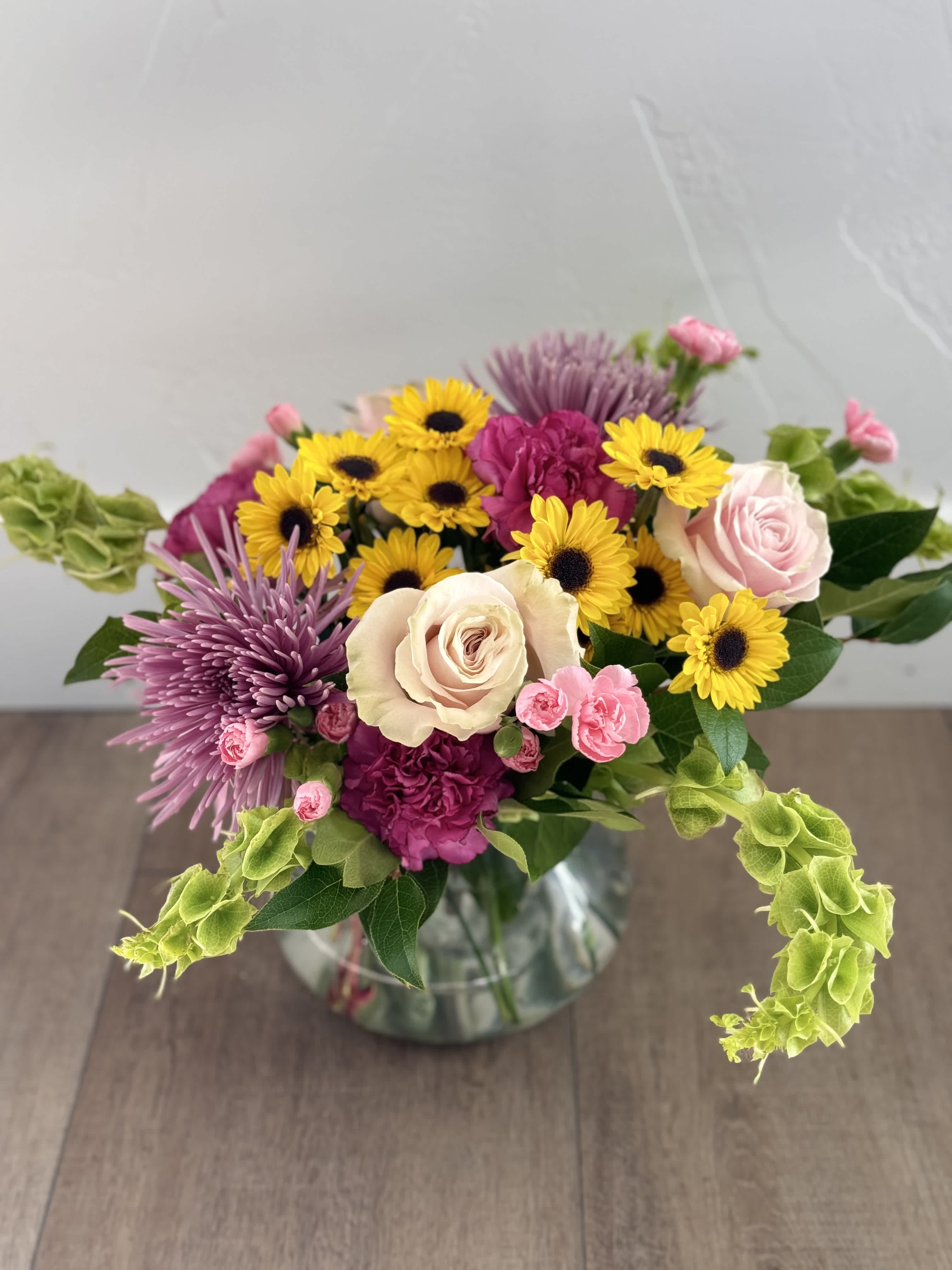 $65 Custom Low arragement - This custom arrangement features 360-degree views of gorgeous flowers!