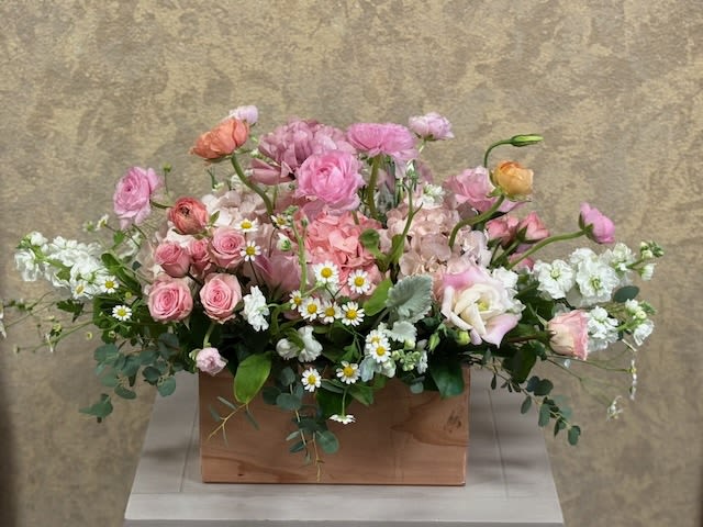 Spring Soirée Celebration - Recipe: Combinations of Pinks and White Hydrangaes, Ranunculus, Snapdragon or Stock, Lisianthus, Roses, Baby Breath, Greens in a local hand-made wooden box. Availability: Seasonal Ranunculus Dimensions: Premium wooden box 11" long regular 14" long 