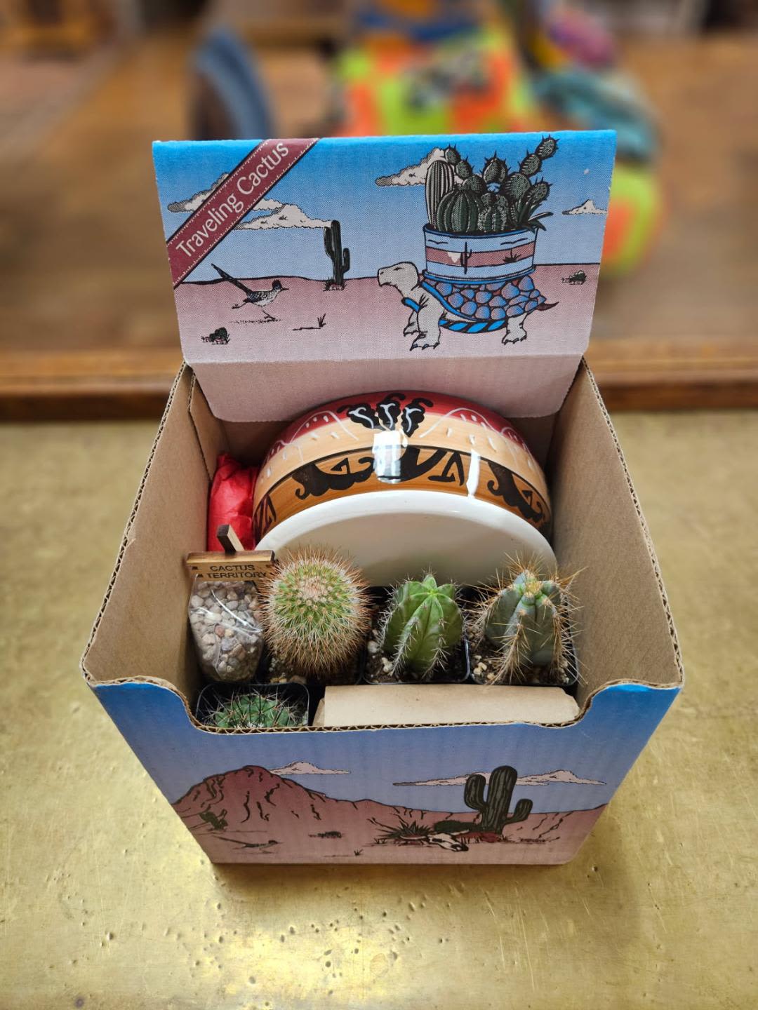 Traveling Cactus Kit  - Traveling cactus kit - the fun is in assembling! Comes with pot, four cacti, potting soil, rocks and wooden sign. (Pot designs vary and wooden sign will either say Yucca Valley, Joshua Tree or Cactus Territory. Please specify if you want a specific sign.)