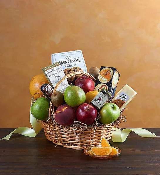 Fruit basket with apples, pears, oranges, and packaged snacks