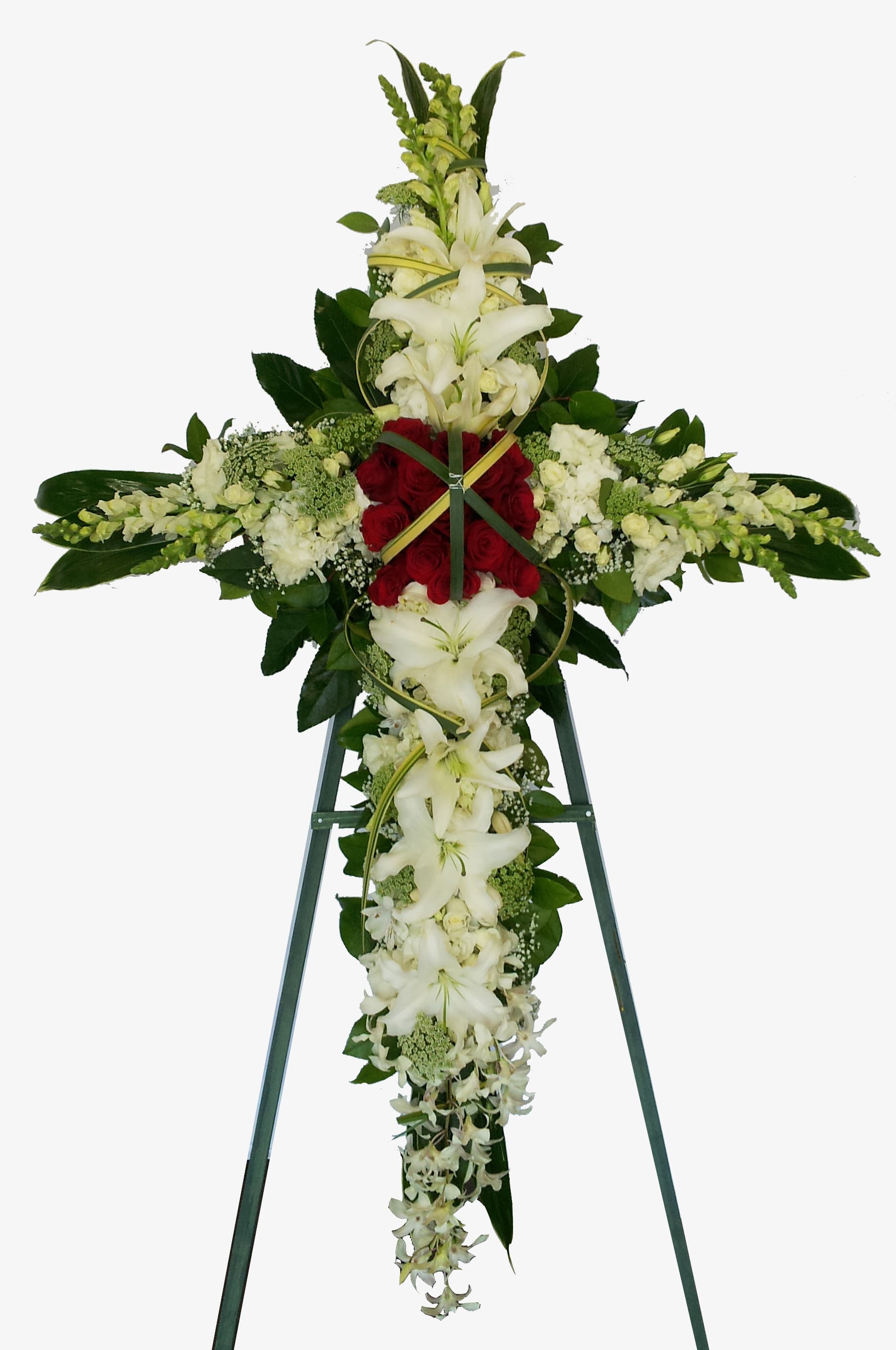 Standing floral cross with white lilies and red roses on an easel