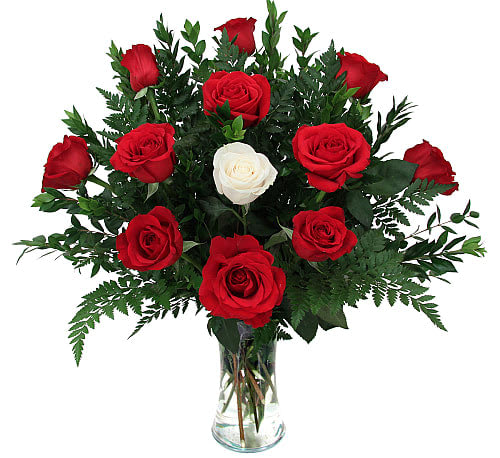 Red and white roses in a clear glass vase